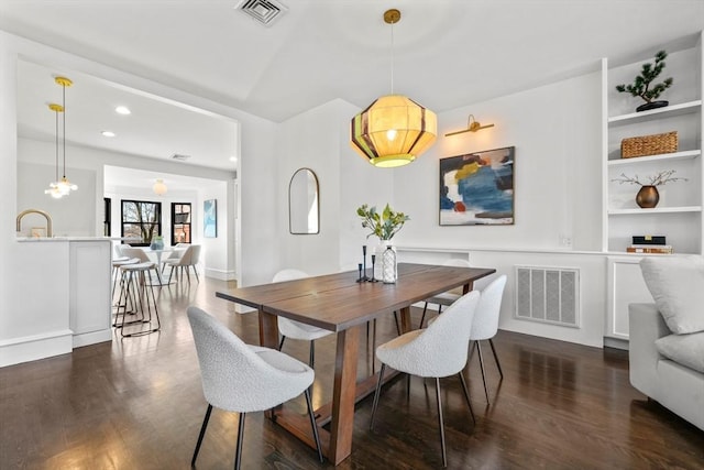 dining space featuring dark wood-type flooring