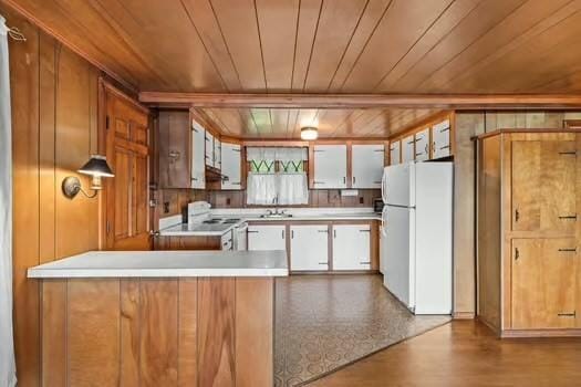 10 Sandpiper Ter, Wareham, MA 02571 - kitchen with white appliances, wood ceiling, light countertops, wood walls, and a sink