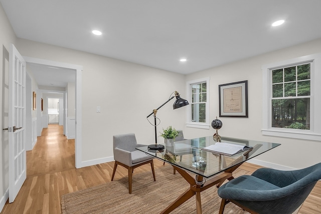 office area with light hardwood / wood-style floors and plenty of natural light