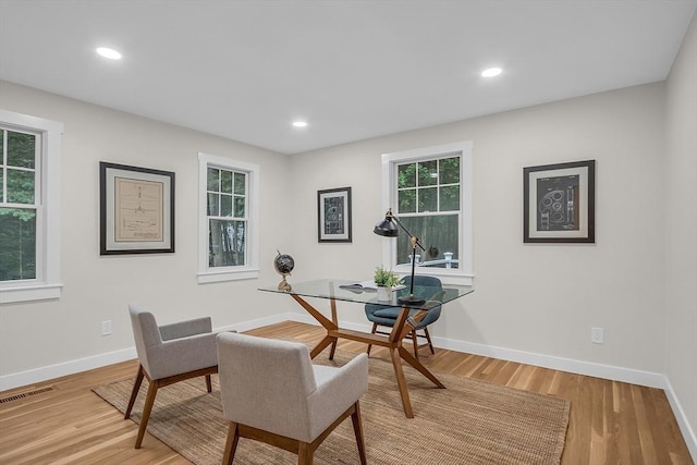 home office with a wealth of natural light and light wood-type flooring