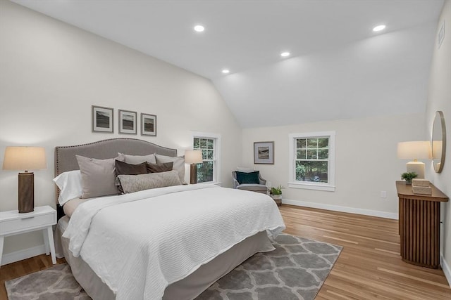 bedroom featuring vaulted ceiling and light wood-type flooring