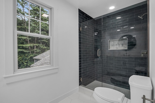 bathroom with toilet, tile patterned floors, and a shower with door