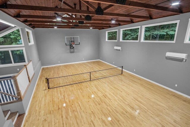 living room with a skylight, beamed ceiling, light hardwood / wood-style flooring, and high vaulted ceiling