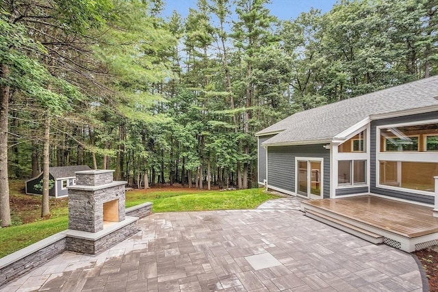 view of patio with an outdoor stone fireplace