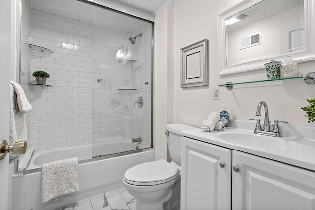 bathroom featuring visible vents, enclosed tub / shower combo, toilet, and vanity