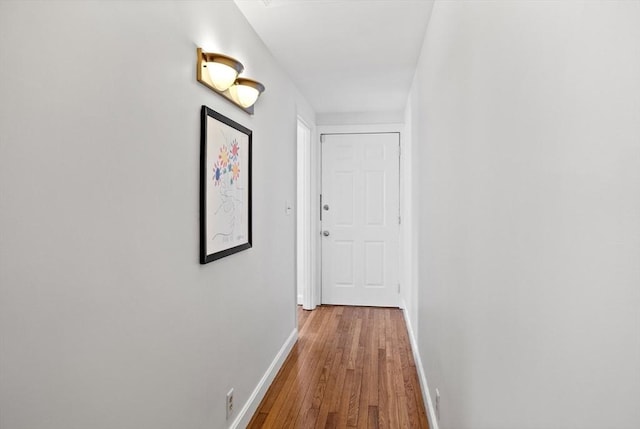 hall with wood finished floors and baseboards