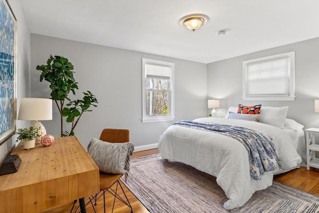 bedroom featuring baseboards and wood-type flooring