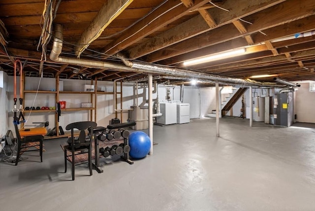 unfinished below grade area featuring water heater, heating unit, stairway, and washer and clothes dryer