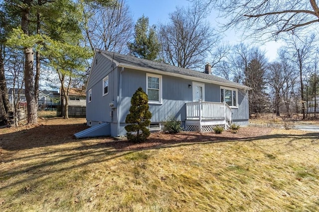 view of front of house featuring a front yard and a chimney