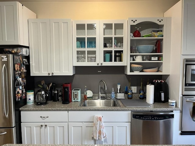 kitchen featuring sink, white cabinets, and appliances with stainless steel finishes