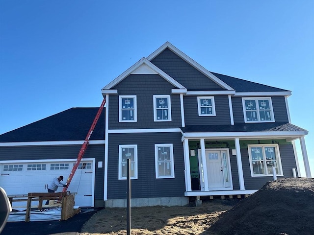 view of front of house with a porch and a garage