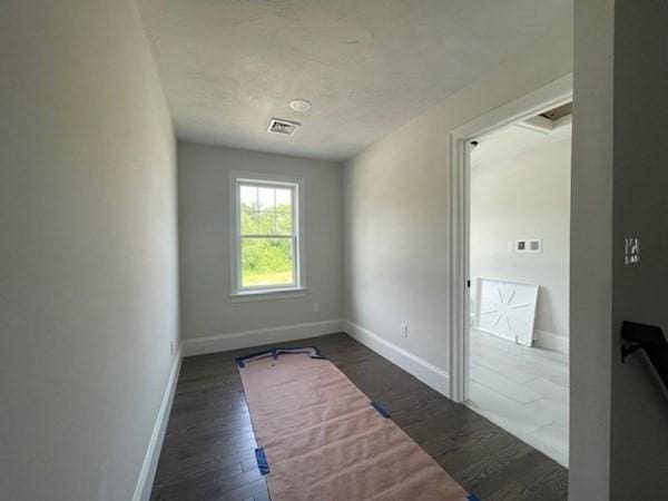 spare room with dark hardwood / wood-style flooring