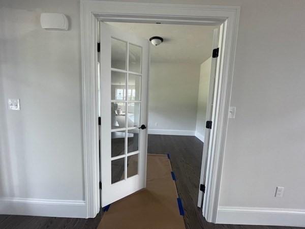 hallway with french doors and dark wood-type flooring