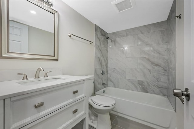 full bathroom with vanity, tile patterned floors, toilet, and tiled shower / bath