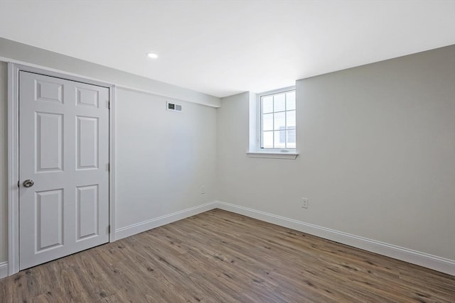 basement with hardwood / wood-style flooring