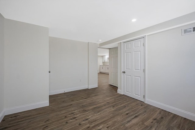 spare room with dark wood-type flooring