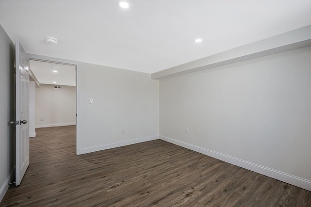 empty room featuring dark wood-type flooring