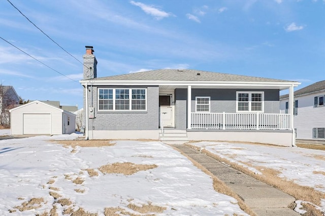 view of front of property with a garage, an outdoor structure, and covered porch