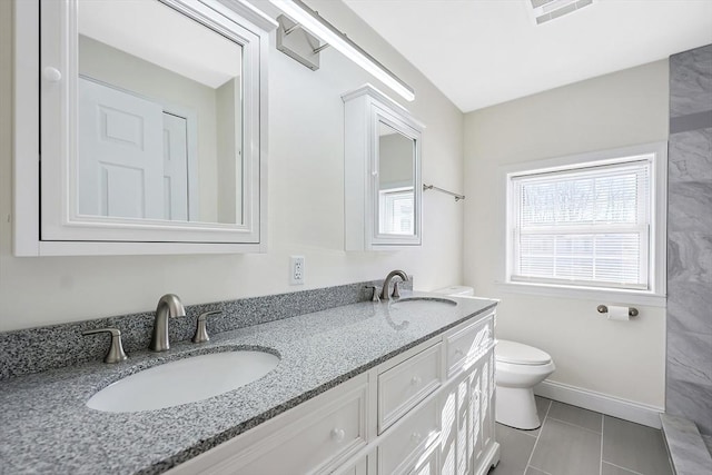 bathroom with tile patterned floors, vanity, and toilet