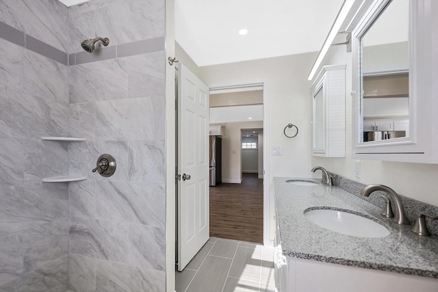 bathroom featuring vanity and a tile shower