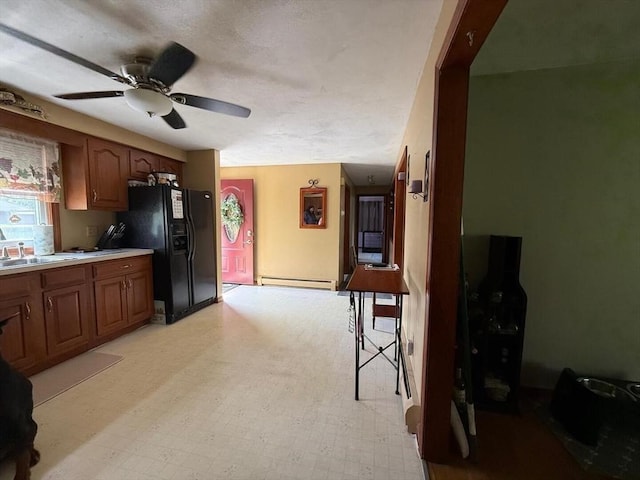 625 Middleboro Ave, Taunton, MA 02718 - kitchen featuring a baseboard heating unit, light floors, ceiling fan, and plenty of natural light