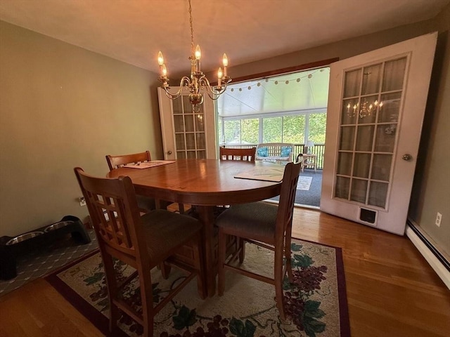 625 Middleboro Ave, Taunton, MA 02718 - dining space with a baseboard heating unit, a chandelier, and wood finished floors