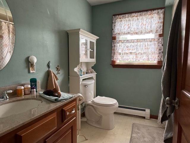 625 Middleboro Ave, Taunton, MA 02718 - full bathroom with a baseboard heating unit, vanity, toilet, and tile patterned floors