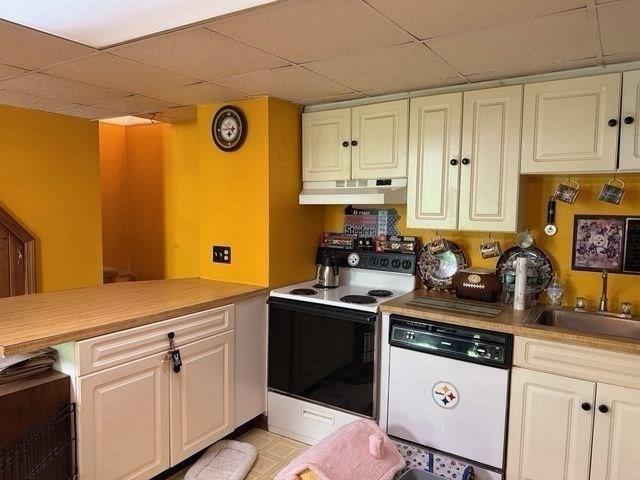 625 Middleboro Ave, Taunton, MA 02718 - kitchen featuring dishwasher, range with electric cooktop, under cabinet range hood, a sink, and a drop ceiling