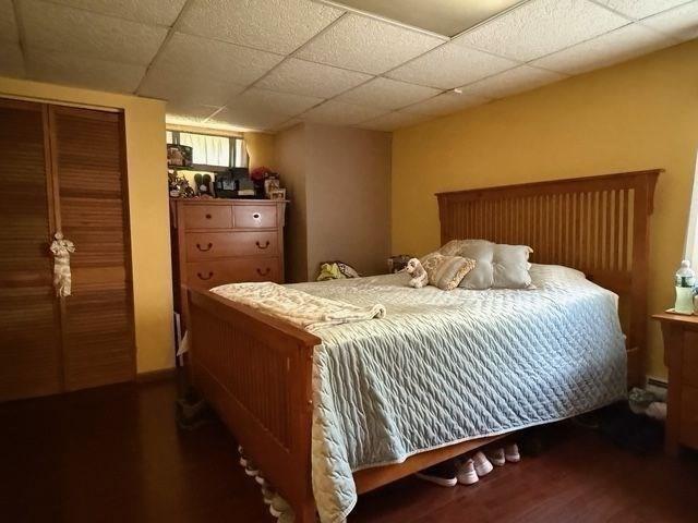 625 Middleboro Ave, Taunton, MA 02718 - bedroom with wood finished floors, a paneled ceiling, and a closet