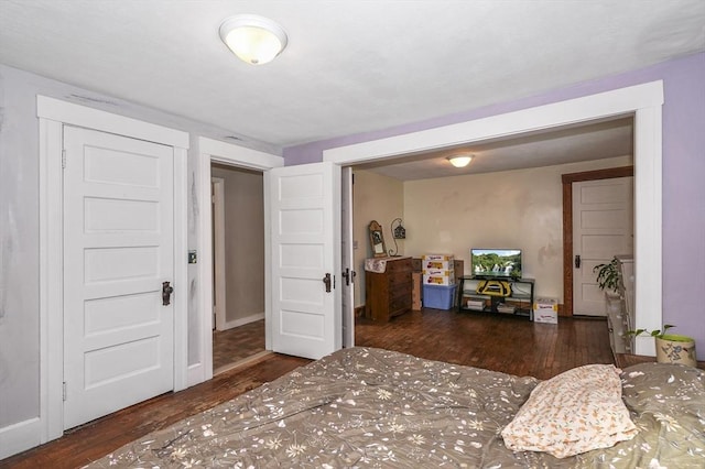 bedroom with dark hardwood / wood-style floors