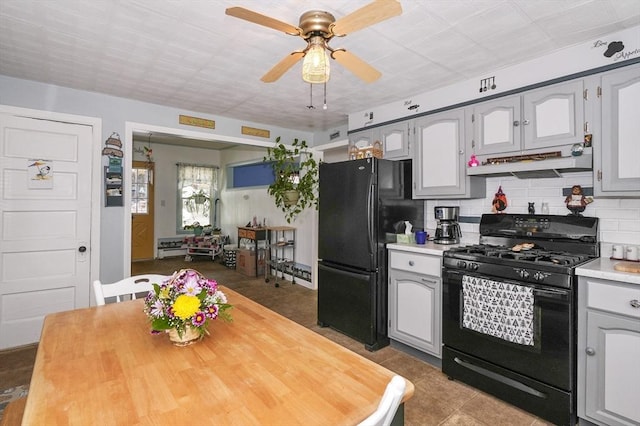 kitchen featuring gray cabinets, ceiling fan, black appliances, and backsplash