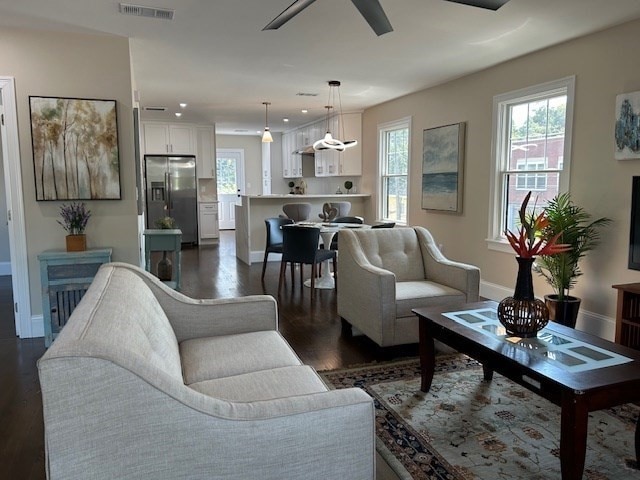 living room featuring dark hardwood / wood-style floors and ceiling fan