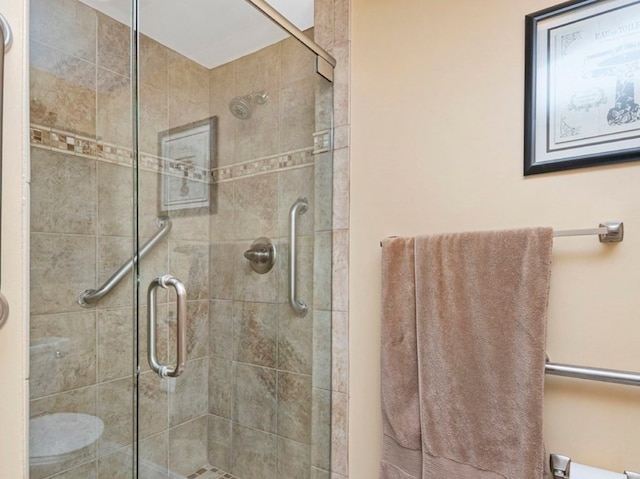 bathroom featuring an enclosed shower and toilet