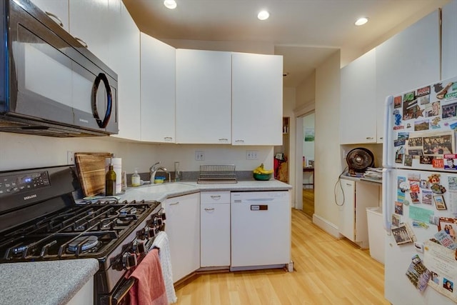 60 Dwight Unit 2, Brookline, MA 02446 - kitchen with white appliances, light wood-style floors, light countertops, white cabinetry, and a sink