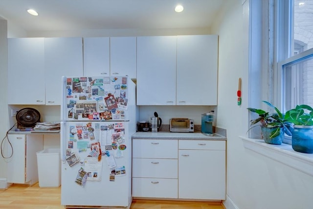 60 Dwight Unit 2, Brookline, MA 02446 - kitchen featuring freestanding refrigerator, light countertops, light wood-type flooring, white cabinetry, and recessed lighting
