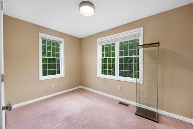 carpeted empty room with baseboards