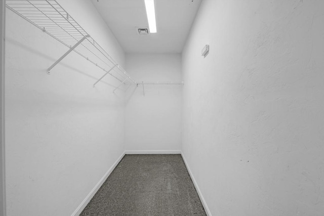 walk in closet with carpet flooring