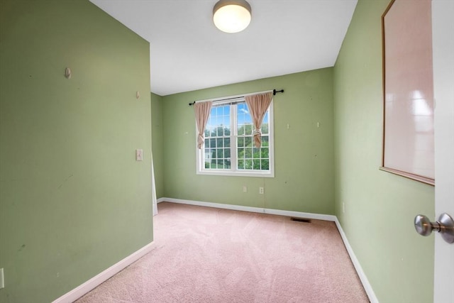 unfurnished room with carpet and baseboards