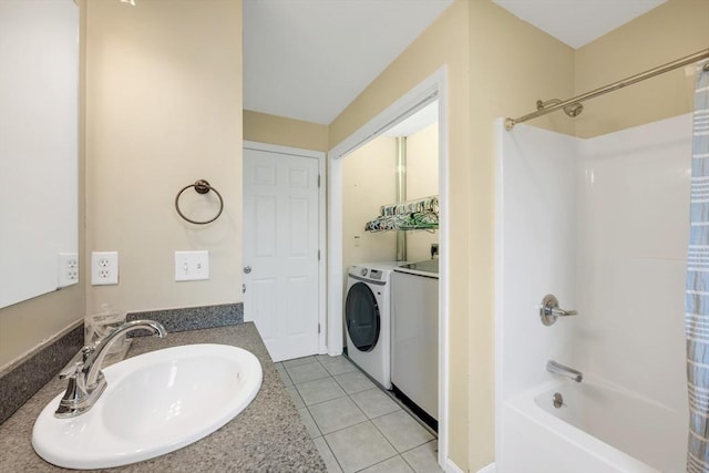 full bath featuring washing machine and clothes dryer, shower / bath combo, vanity, and tile patterned flooring