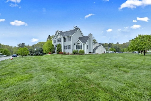 view of side of property with a yard