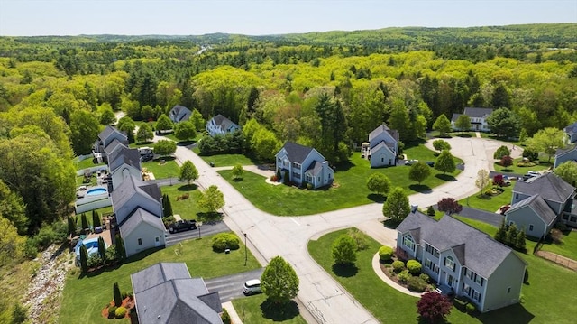 aerial perspective of suburban area featuring a forest