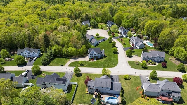 aerial perspective of suburban area featuring a heavily wooded area