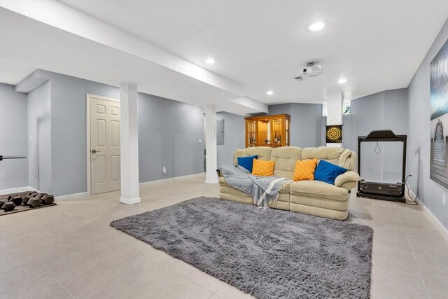 tiled living room featuring baseboards, electric panel, and recessed lighting