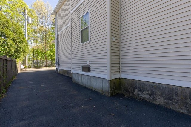 view of side of property featuring fence