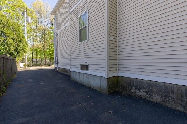 view of side of home with fence