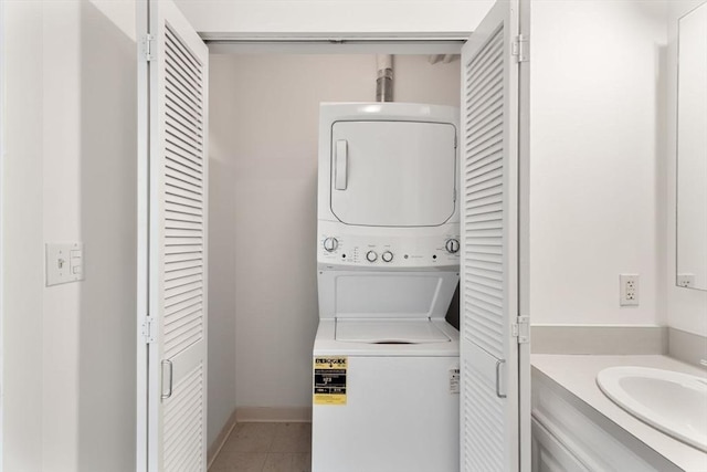 519 Harrison Ave Unit D117, Boston, MA 02118 - laundry room with stacked washer and clothes dryer and light tile patterned floors