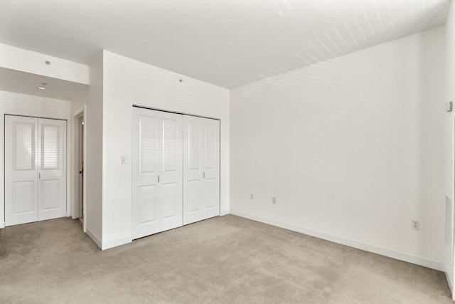 519 Harrison Ave Unit D117, Boston, MA 02118 - unfurnished bedroom featuring light colored carpet and a closet