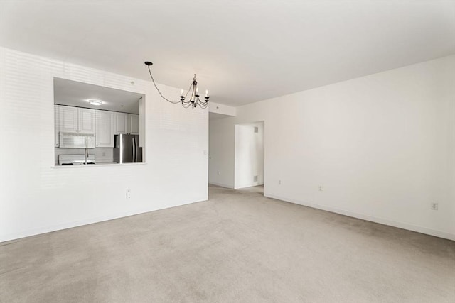 519 Harrison Ave Unit D117, Boston, MA 02118 - spare room with a chandelier and light colored carpet
