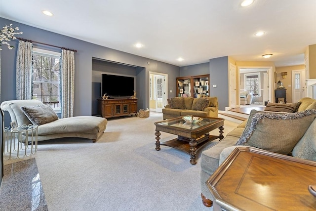 living area with recessed lighting and light colored carpet