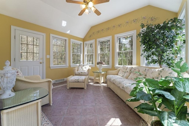 sunroom / solarium with tile patterned floors, visible vents, lofted ceiling, and baseboards